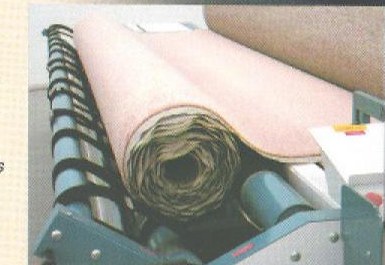 Carpet being reverse rolled pile-side out on the Arrow