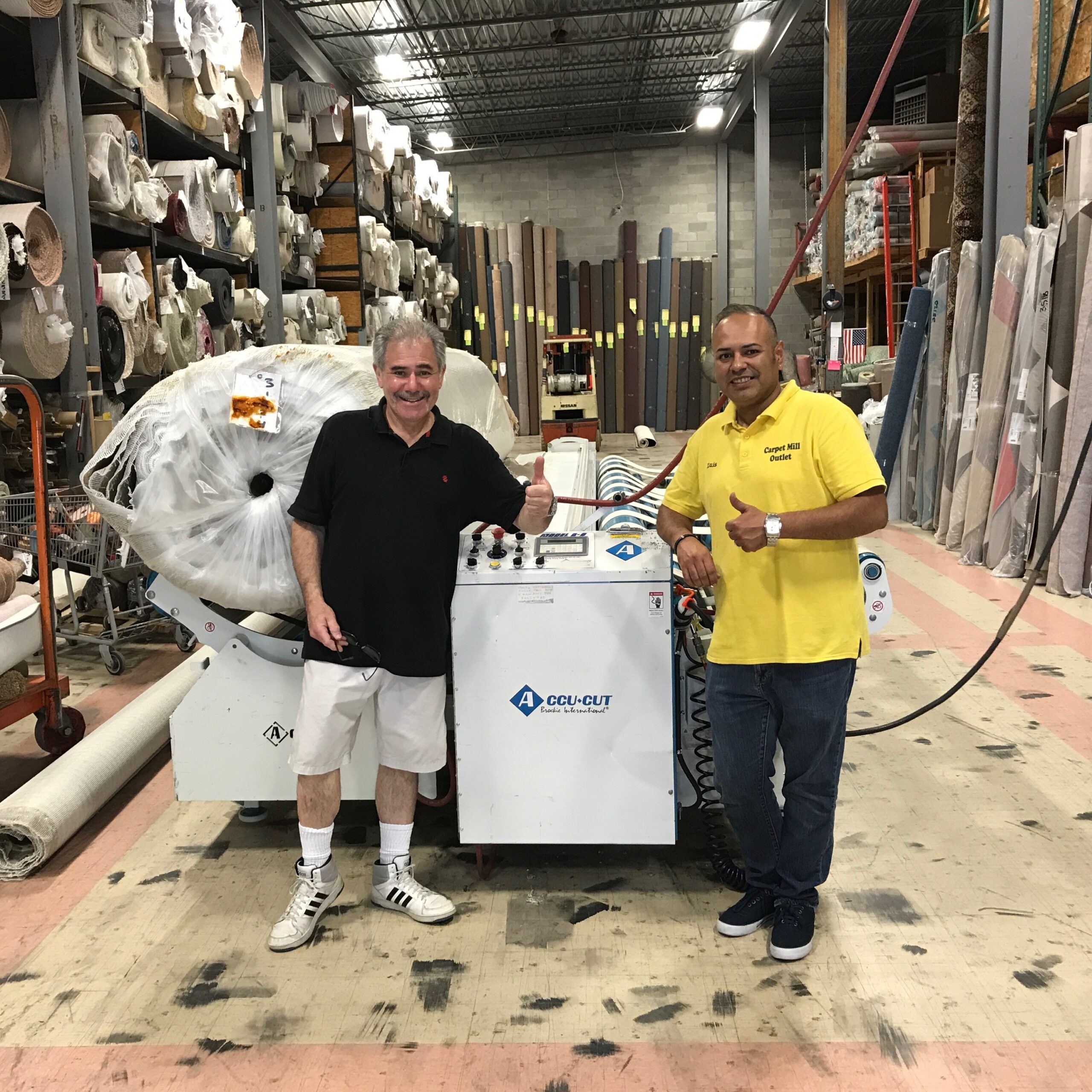 Picture of Ken Borden and Luis at carpet mill outlet in New York