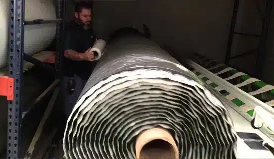 Accu-Cut Machine wrapping large roll of artificial turf. Accu-Cut Machine wrapping large roll of artificial turf.
